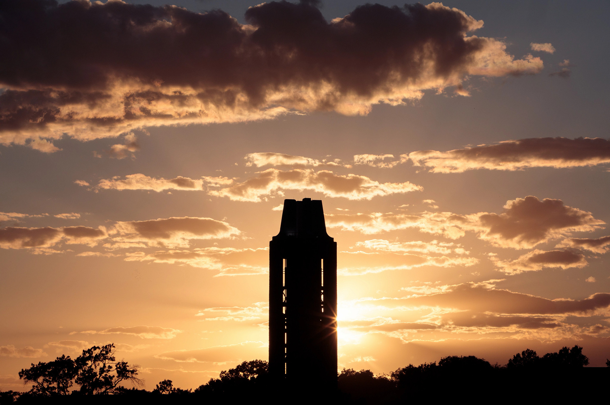 campanile silhouetted by setting sun