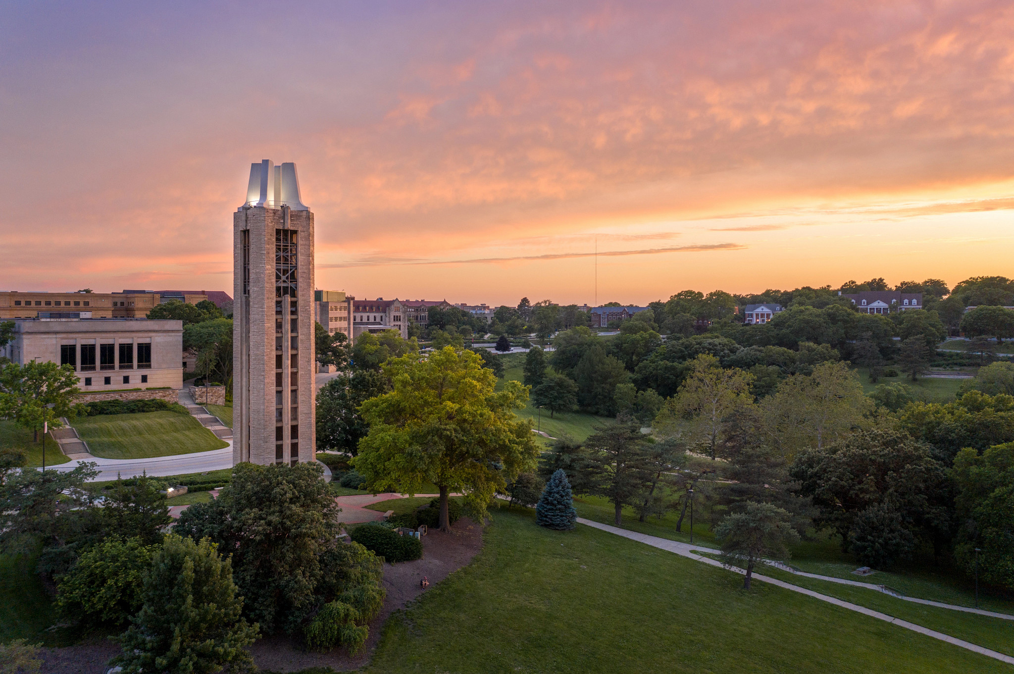 aerial view of campanile looking toward spencer research library with a sunset in the background