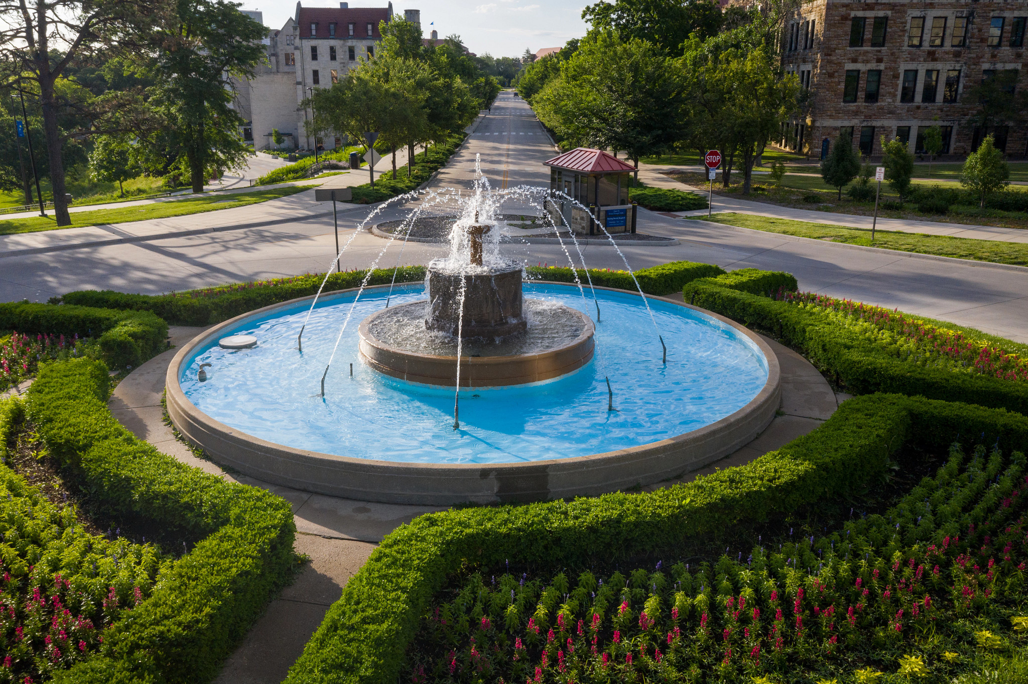 fountain with multiple jets of water with a street behind it